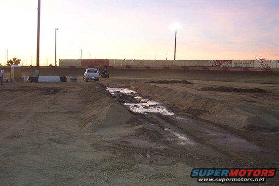 White pickup truck on dirt track
