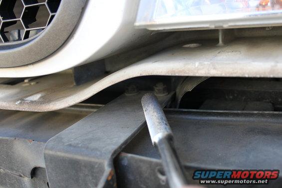 Push bar mounting bracket with bolts visible