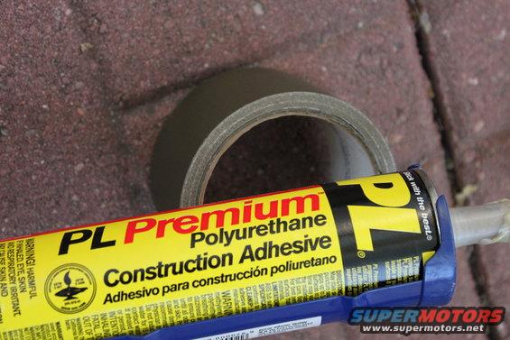 Tube of PL Premium Polyurethane Construction Adhesive and a roll of duct tape on a brick surface