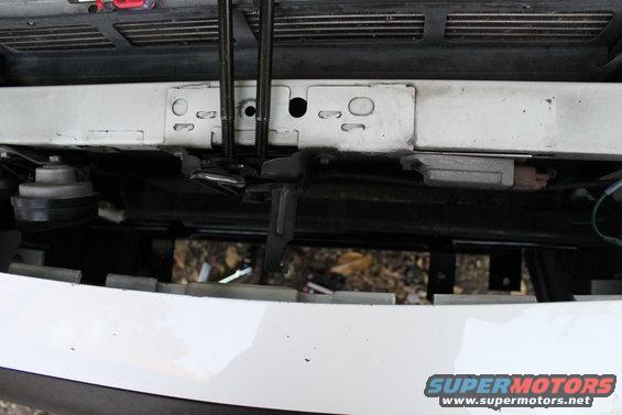 White 2003 Ford Crown Victoria front bumper with visible mounting brackets and a horn