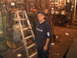 2003 Ford Crown Victoria - A man is standing in a workshop filled with various tools and equipment.