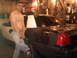 2003 Ford Crown Victoria - A man poses next to a dark sedan with a white roof inside a cluttered garage.