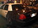 2003 Ford Crown Victoria - This 2003 Ford Crown Victoria is undergoing a paint job, with the rear half painted black and the front half white.