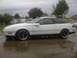 1989 Ford Probe - This 1989 Ford Probe is shown from the side on a cloudy day, reflecting in puddles.