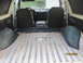 1989 Ford Bronco - The interior of a 1989 Ford Bronco, its front seats, dashboard, and spacious cargo area.