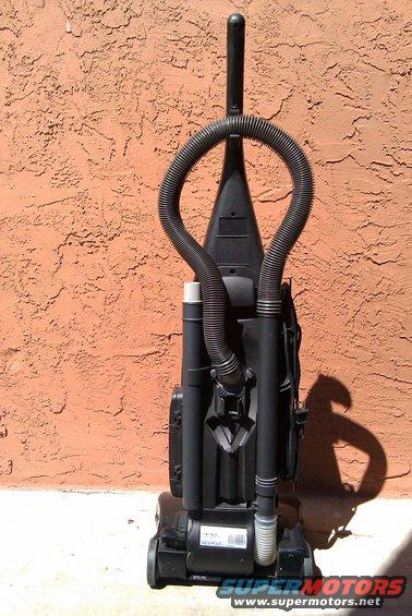 Black upright vacuum cleaner with hose