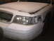 2003 Ford Crown Victoria - Front view of a white Ford Crown Victoria undergoing repairs, with visible damage to the headlight area and grille.