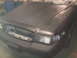 2003 Ford Crown Victoria - Front view of a 2003 Ford Crown Victoria in primer, with the grille removed and headlights covered.