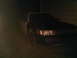 2003 Ford Crown Victoria - A dark Ford Crown Victoria is parked outside at night, showing its front end.
