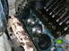 1979 Ford F-150 - Close-up view of an engine block, showing pistons and an exhaust manifold. The condition suggests internal engine work.