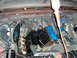 1979 Ford F-150 - Engine bay work in progress, showing blue valve covers and a syringe in use.