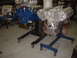 1965 Ford 427 - Two engines are displayed on stands in a workshop environment.