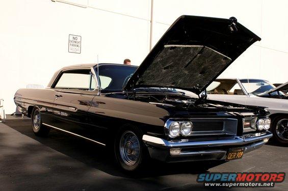 Black 1961 Pontiac Catalina two-door hardtop with hood open, parked next to another car
