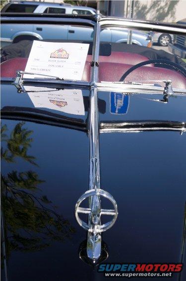 Black convertible hood ornament and windshield with 1946 Buick Super sign