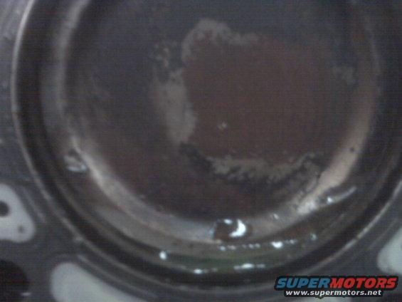 Engine cylinder with dark fluid and white residue