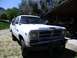 1987 Dodge 1500 - This 1987 Dodge Ram pickup truck is seen from the front in a yard setting.