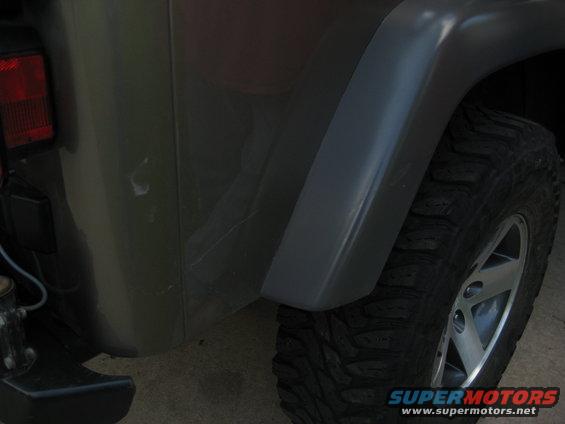 Gray Jeep Wrangler rear quarter panel and tire