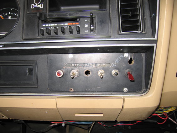 Dashboard interior showing auxiliary switches labeled DEF, M, WIP, and a red key switch