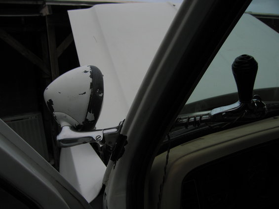 Side mirror and window crank inside a truck with the hood open