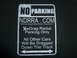 1992 Ford Mustang - A sign indicates parking restrictions for drag radial vehicles and warns other cars.