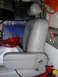 1998 Mercury Grand Marquis - A single car seat is shown in a cluttered garage setting with various storage containers and tools visible.