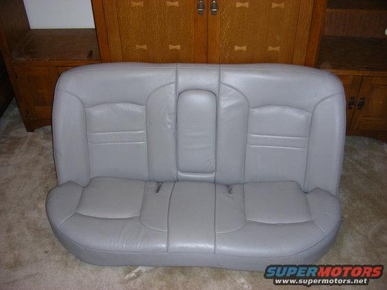 Gray leather rear car seat with fold-down armrest
