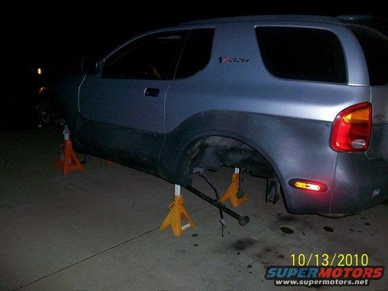 Blue Isuzu VehiCROSS on jack stands with rear wheels removed