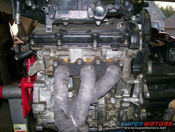 Engine block with exhaust manifold wrapped in heat-resistant material