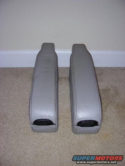 pair of gray armrests with black plastic end caps