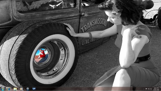 Woman in red dress touching whitewall tire of vintage car with 'TRANSMISSIONS UNLIMITED' text