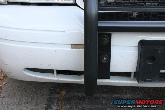 White 2003 Ford Crown Victoria front bumper with black push bar and license plate bracket