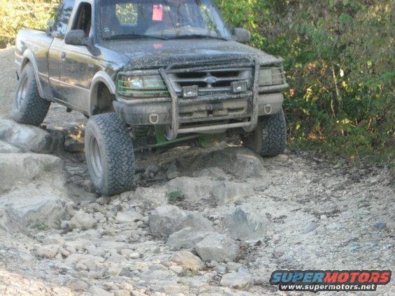 1995 Ford Ranger on rocks, front view, dark color