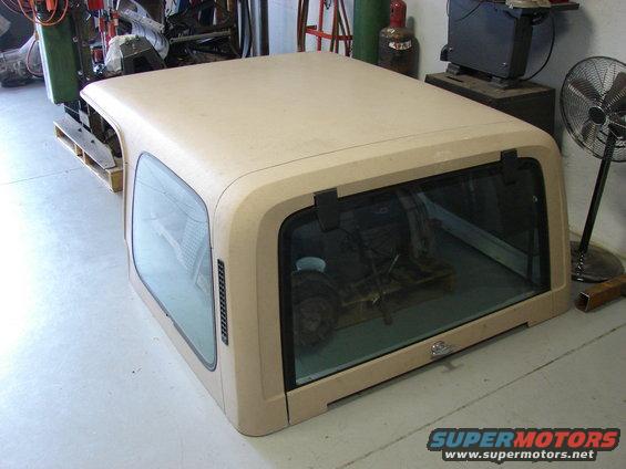 Tan Jeep hardtop with tinted windows