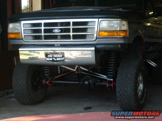 Front view of lifted Ford truck with chrome grille and a license plate that says 'EVIL-WICHED MEAN NASTY'