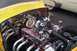 1991 Ford Crown Victoria - A highly customized V8 engine with chrome and gold accents is visible in the engine bay of a yellow car, with another classic car in the ba…
