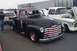 1991 Ford Crown Victoria - Two classic Chevrolet pickup trucks, a black 1950 model and a white one, are displayed side-by-side.