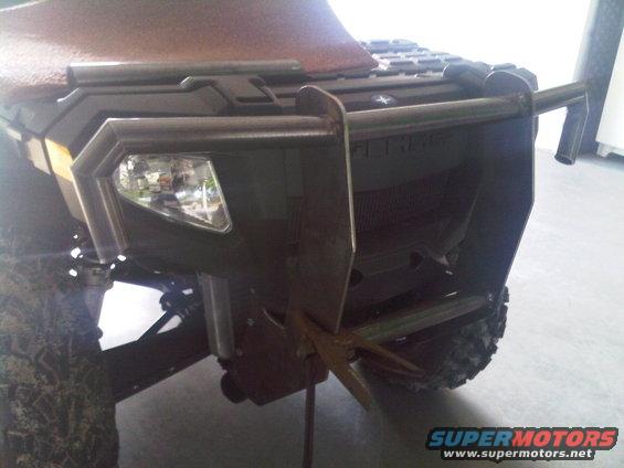 ATV front bumper with integrated headlights and a metal brush guard