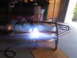 2004 Harley-Davidson Fat Boy - A person is welding a metal frame, which appears to be a custom part for a vehicle, possibly a motorcycle.