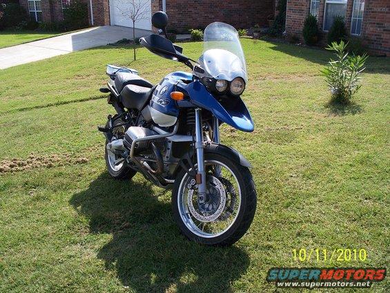 Blue and silver 2001 BMW R1150GS ABS motorcycle parked on grass, front 3/4 view