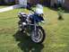 2001 BMW R1150GS ABS - A blue and silver 2001 BMW R1150GS ABS motorcycle is parked on a grassy lawn in front of a brick house.