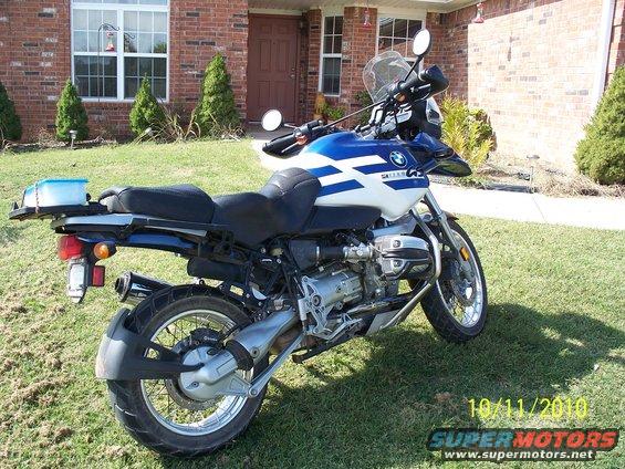 Blue and white BMW motorcycle parked on grass