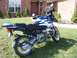 2001 BMW R1150GS ABS - A blue and white BMW motorcycle is parked on a grassy lawn in front of a brick house.