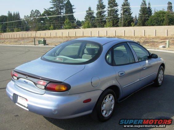 Light blue 1997 Ford Taurus, rear 3/4 view
