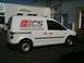 2009 Holden Commodore - A white panel van with "ECS INNOVATIVE CARD SYSTEMS" branding is parked outside a building.
