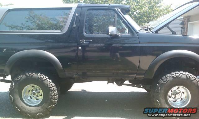 Side view of a black 1994 Ford Bronco with lifted suspension and off-road tires