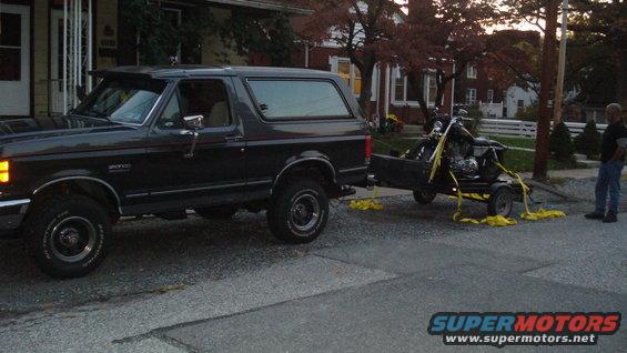 1988 Ford Bronco side view towing a motorcycle