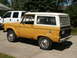1966 Ford Bronco - This 1966 Ford Bronco is seen in a 3/4 front view, parked beside a white pickup truck.