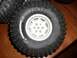 1994 Ford Escort - This image shows a close-up of an off-road tire, identified as ROKLOX 1.9 Comp Tires, with its aggressive tread pattern.