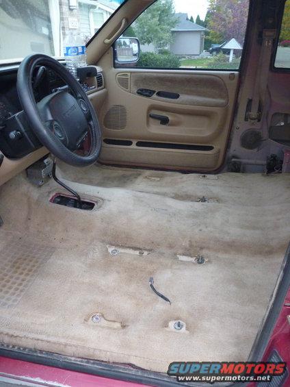 Interior of a 1997 Dodge 2500 with carpet removed, showing the floor and dashboard
