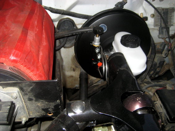 Brake booster and master cylinder assembly in engine bay